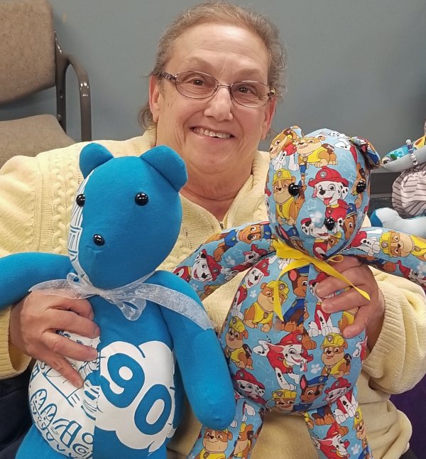 A woman holds two Memory Bears at a Chicago reunion