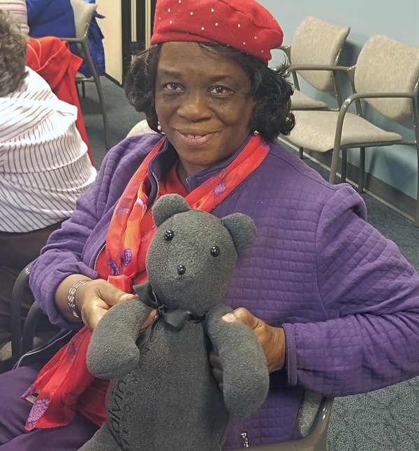A woman holds a Memory Bear at a reunion in Chicago