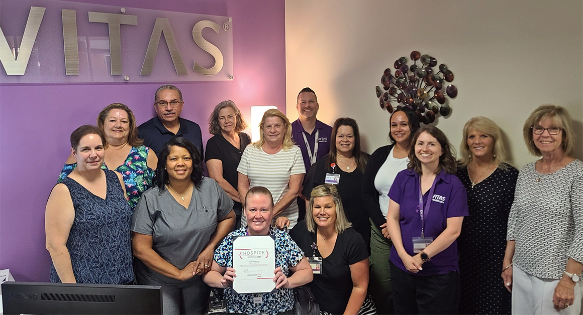 Smiling hospice workers pose with their CAHPS Honors Award.