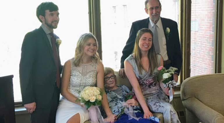 Wedding participants smiling with hospice patient