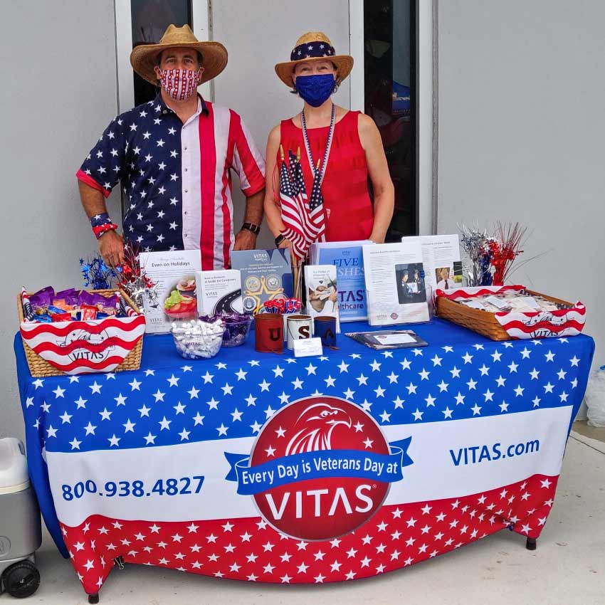 A patriotic VITAS table with educational information about honoring veterans near end of life