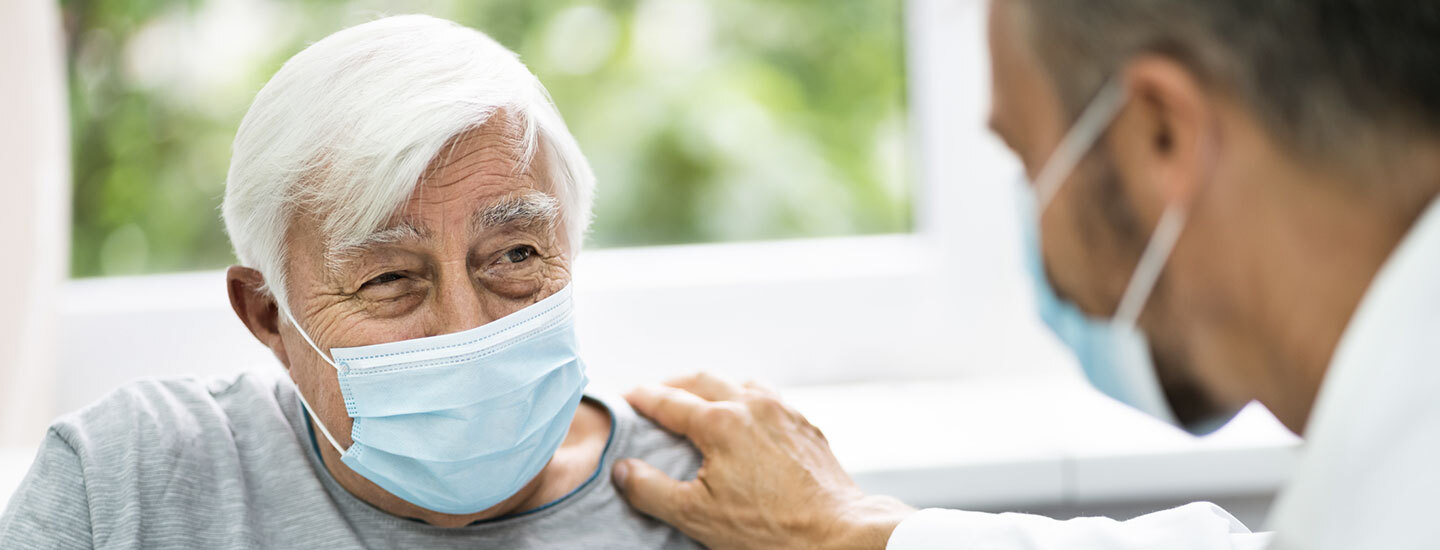 A physician talks with his patient