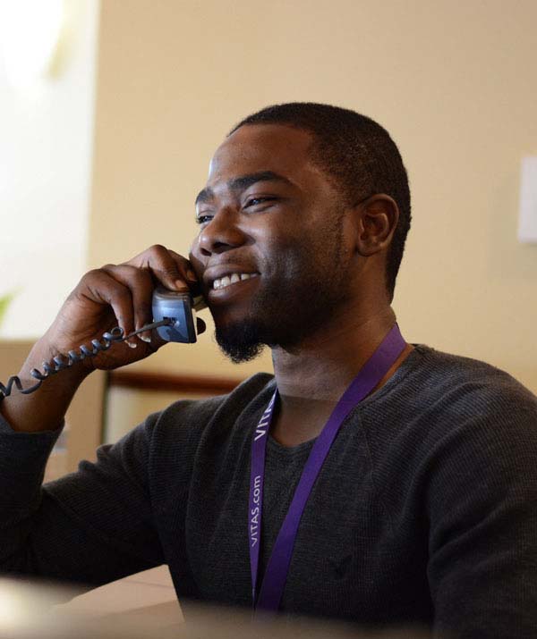 A VITAS team member answers a call